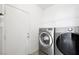 Convenient laundry room with modern washer and dryer, offering practicality and efficiency for household chores at 9104 Ashiwi Ave, Las Vegas, NV 89178