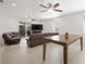 Bright living room featuring tile floors, a ceiling fan, and sliding glass doors leading to the outdoor space at 9104 Ashiwi Ave, Las Vegas, NV 89178