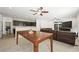 Spacious open-concept living space with tile floors, ceiling fan, and abundant natural light at 9104 Ashiwi Ave, Las Vegas, NV 89178