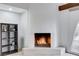Elegant fireplace with unique pebble accents and a modern white surround, flanked by shelving and a window at 945 Vegas Valley Dr, Las Vegas, NV 89109