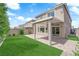 Beautiful backyard with lush lawn, mature trees, and covered patio for outdoor relaxation at 9604 Stoney Mesa Ct, Las Vegas, NV 89139