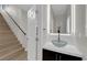 Stylish powder room with floating vessel sink and modern fixtures, adjacent to staircase at 9604 Stoney Mesa Ct, Las Vegas, NV 89139