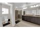 Spacious bathroom features a double vanity, walk-in shower with glass door and updated fixtures at 9604 Stoney Mesa Ct, Las Vegas, NV 89139