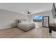 Bright bedroom with a ceiling fan, a large window, and light wood-look flooring at 9604 Stoney Mesa Ct, Las Vegas, NV 89139