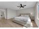 Large, bright bedroom with a ceiling fan, natural light, and light wood-look flooring at 9604 Stoney Mesa Ct, Las Vegas, NV 89139