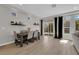 Elegant dining area featuring wood floors, stylish decor, and sliding glass doors for outdoor access at 9604 Stoney Mesa Ct, Las Vegas, NV 89139