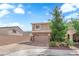 Charming two-story home featuring a brick driveway and a well-maintained front yard with mature trees at 9604 Stoney Mesa Ct, Las Vegas, NV 89139