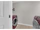 Bright laundry room featuring side-by-side washer and dryer, and ample space at 9604 Stoney Mesa Ct, Las Vegas, NV 89139