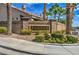 Attractive community entrance sign with mature palm trees and landscaping at 9621 Donner Springs Ave, Las Vegas, NV 89148