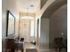 Welcoming entryway featuring a decorative mirror, piano, and a charming overhead light at 9621 Donner Springs Ave, Las Vegas, NV 89148