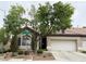 Charming single-story home featuring a well-maintained front yard, two-car garage, and mature shade trees at 9621 Donner Springs Ave, Las Vegas, NV 89148