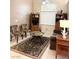 Cozy living room featuring a decorative rug, ceiling fan, and abundant natural light at 9621 Donner Springs Ave, Las Vegas, NV 89148