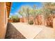 Backyard with brick pavers, block wall, artificial turf, and mature trees at 9987 Shiloh Heights St, Las Vegas, NV 89178