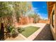Backyard with brick pavers, artificial turf, block wall, and desert landscaping at 9987 Shiloh Heights St, Las Vegas, NV 89178