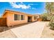Backyard area with brick pavers, artificial turf, and mature shade trees at 9987 Shiloh Heights St, Las Vegas, NV 89178