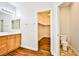 Bathroom features a wood vanity with walk-in closet and attached toilet room at 9987 Shiloh Heights St, Las Vegas, NV 89178