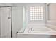 Modern primary bathroom with separate glass enclosed shower and garden tub at 9987 Shiloh Heights St, Las Vegas, NV 89178