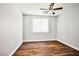 A naturally lit bedroom with wood-look flooring and a modern ceiling fan at 9987 Shiloh Heights St, Las Vegas, NV 89178