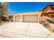 Charming single story home featuring a tile roof, a two car garage, and desert landscaping at 9987 Shiloh Heights St, Las Vegas, NV 89178