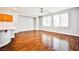 Bright living room area showing wood floors, a ceiling fan, and ample natural light at 9987 Shiloh Heights St, Las Vegas, NV 89178