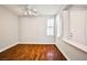 Bright, open living room with hardwood floors, ceiling fan, and natural light from the window at 9987 Shiloh Heights St, Las Vegas, NV 89178