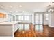 Spacious living area with hardwood floors leading to the kitchen and outdoor patio through sliding doors at 9987 Shiloh Heights St, Las Vegas, NV 89178