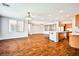 Expansive living space featuring hardwood floors, ample natural light, and a seamless flow to the kitchen at 9987 Shiloh Heights St, Las Vegas, NV 89178