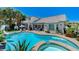 Resort-style backyard with a sparkling pool, spa, and mature palm trees at 10249 Wisteria Hills Ct, Las Vegas, NV 89135