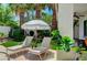 Backyard with a pair of lounge chairs, an umbrella and some lush landscaping at 10249 Wisteria Hills Ct, Las Vegas, NV 89135