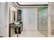 This bathroom features double sinks, a large walk-in shower, and custom cabinets at 10249 Wisteria Hills Ct, Las Vegas, NV 89135