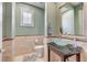 Powder bathroom featuring unique glass bowl sink atop granite countertop, tile accents, and decorative mirror at 10249 Wisteria Hills Ct, Las Vegas, NV 89135