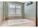 This bathroom features a large tub and a window for natural light at 10249 Wisteria Hills Ct, Las Vegas, NV 89135