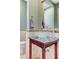 Powder bathroom featuring unique glass bowl sink atop granite countertop, tile accents, and decorative mirror at 10249 Wisteria Hills Ct, Las Vegas, NV 89135