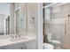 Bright bathroom with white vanity and countertops, large mirror, and access to private shower and toilet at 10249 Wisteria Hills Ct, Las Vegas, NV 89135