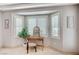 This main bedroom features a lovely bay window sitting area and neutral decor at 10249 Wisteria Hills Ct, Las Vegas, NV 89135