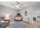Cozy Bedroom with wooden crib, comfortable chair, and a playful rug creating a serene atmosphere at 10249 Wisteria Hills Ct, Las Vegas, NV 89135