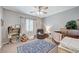 Charming Bedroom with hardwood crib, cozy armchair, and playful decor for a welcoming space at 10249 Wisteria Hills Ct, Las Vegas, NV 89135