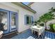 Charming outdoor dining area with stone tile, shaded patio, and an entrance into the house at 10249 Wisteria Hills Ct, Las Vegas, NV 89135