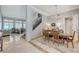 Bright dining room with staircase, chandelier, marble floors, and views into the living room at 10249 Wisteria Hills Ct, Las Vegas, NV 89135