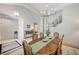 Formal dining room with chandelier and staircase with decorative wrought iron railing at 10249 Wisteria Hills Ct, Las Vegas, NV 89135