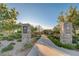 A beautiful entrance to the Gardens Park features stone monuments and a well-maintained walkway at 10249 Wisteria Hills Ct, Las Vegas, NV 89135
