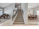 Spacious foyer showcasing the staircase, piano, and adjacent dining area at 10249 Wisteria Hills Ct, Las Vegas, NV 89135