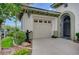 Attached two-car garage, manicured landscaping, and gated courtyard entryway at 10249 Wisteria Hills Ct, Las Vegas, NV 89135