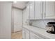 White cabinets and subway tile backsplash in this well-lit kitchen, with stainless steel appliances at 10249 Wisteria Hills Ct, Las Vegas, NV 89135