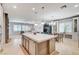 Open concept kitchen with a large island and adjacent living and dining areas at 10249 Wisteria Hills Ct, Las Vegas, NV 89135