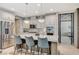 Kitchen island with seating and stainless steel appliances, perfect for entertaining at 10249 Wisteria Hills Ct, Las Vegas, NV 89135