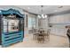 Bright kitchen with a dining table, featuring white cabinets, a chandelier, and a unique blue cabinet at 10249 Wisteria Hills Ct, Las Vegas, NV 89135