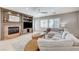 Comfortable living room with a fireplace, built-in shelving, and neutral tones at 10249 Wisteria Hills Ct, Las Vegas, NV 89135