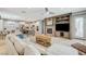 Open-concept living room featuring a fireplace, built-ins, and a view of the kitchen and dining area at 10249 Wisteria Hills Ct, Las Vegas, NV 89135