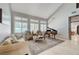 Bright living room featuring a piano, sofa, and lots of natural light from large windows at 10249 Wisteria Hills Ct, Las Vegas, NV 89135